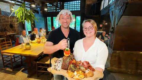  Tobi Kämmerer (li., mit Servier-Haube) und Kellnerin Julia Päsler im mittelalterlichen Erlebnis-Restaurant Wetterburg.